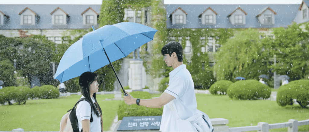 K-drama couple with blue umbrella at Choongang High School in rain