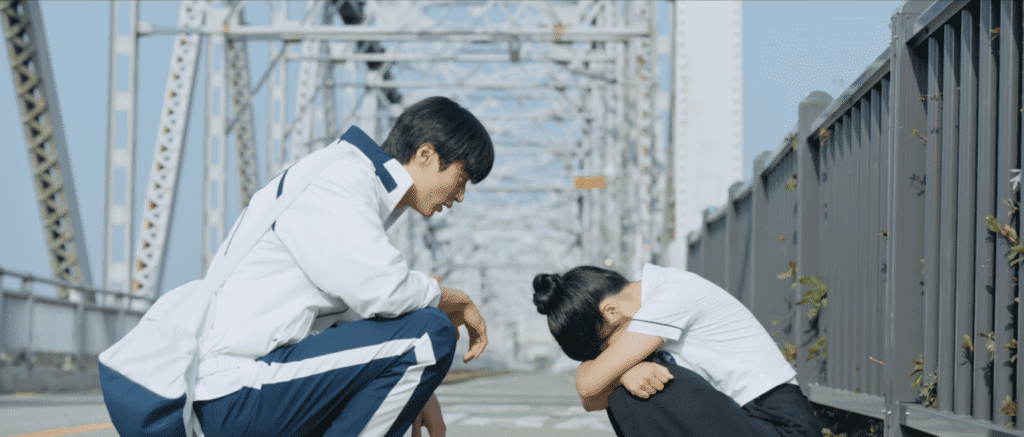 K-drama couple at Geumgang Bridge with river and metal railings