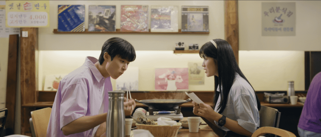 K-drama couple dining at Namdobunsik Ikseon with framed artwork